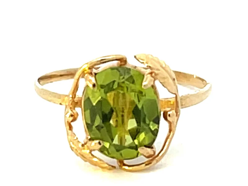 Women’s statement silver rings-Oval Peridot and Leaf Ring in 14k Yellow Gold